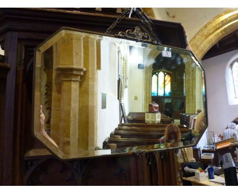 A large 1920's bevel plate mirror in ornate copper frame.