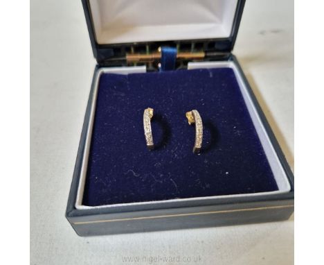 A pair chip diamond ear studs set in unmarked yellow metal, probably gold.