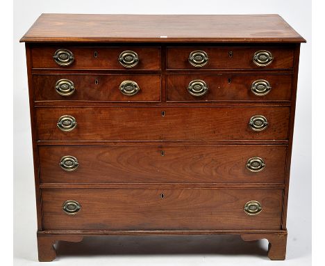 A George III mahogany chest of four short and three long graduating drawers fitted later embossed brass handles, raised on br