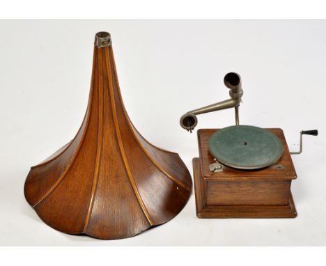 An early 20th Century gramophone, the ribbed and flared oak horn on metal fitting, the turntable and mechanism in oak case, t