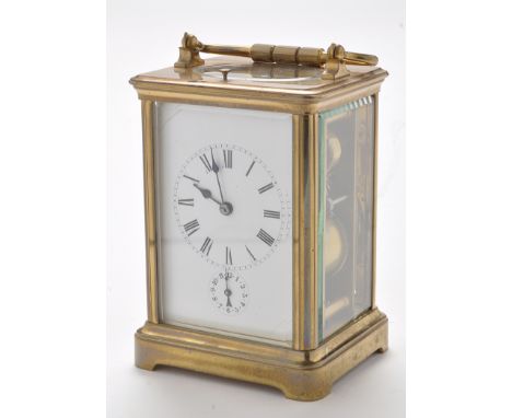 A late 19th Century brass carriage alarm clock, with white enamelled roman dial and alarm dial below, platform lever escapeme