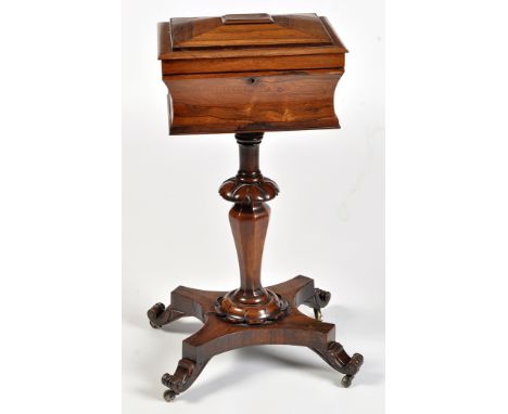 A Regency rosewood teapoy, the caddy top raised on carved octagonal support and shaped plinth with scrolling feet terminating