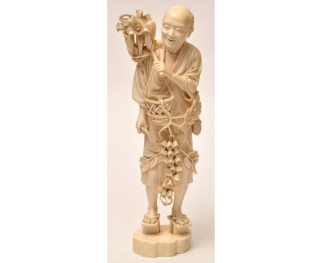 Large Japanese Meiji period ivory figure of a harvester, with flowers over his shoulder and suspended from a hand-basket, whi