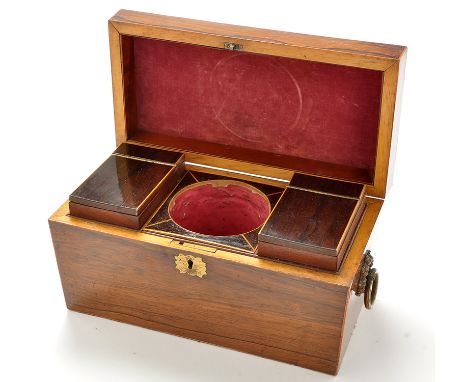 An early 19th Century rosewood sarcophagus form tea caddy decorated with stringing, opening to reveal two canisters and a rec