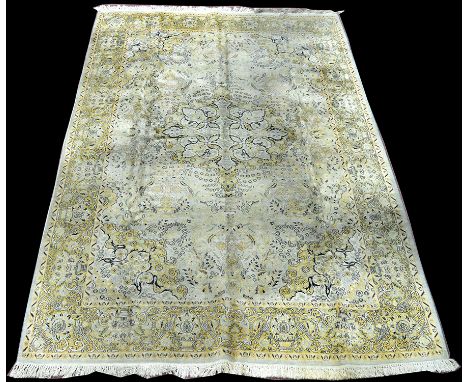 A cashmere carpet, with central floral medallion on light coloured ground, 284 x 181cms (112 x 71in.).