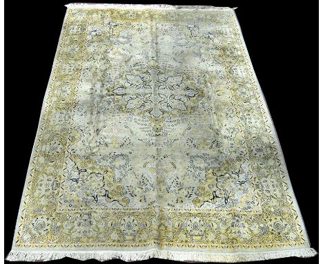 A cashmere carpet, with central floral medallion on light coloured ground, 284 x 181cms (112 x 71in.).