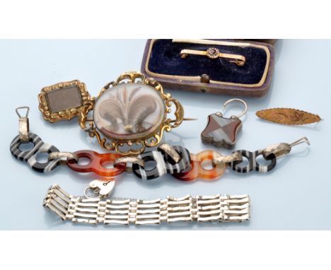 A group of jewellery, comprising: a banded agate and white metal bracelet, 20cms long; two mourning brooches with plaited hai