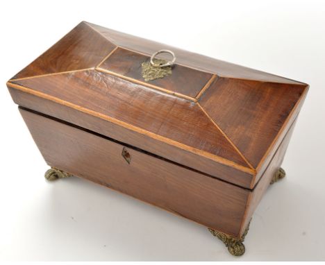 An early 19th Century mahogany sarcophagus form tea caddy, decorated with stringing, fitted brass handle and feet, 11 x 5 1/2