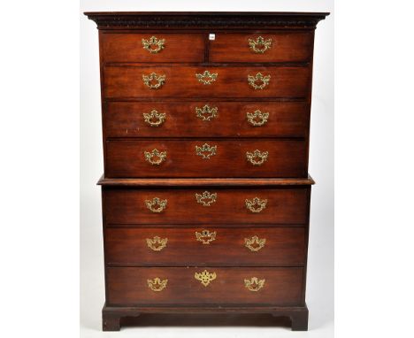 A George III mahogany chest on chest, the flared acanthus carved cornice above two short and six long graduated drawers all f