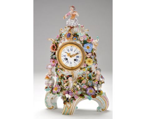 An ornate late 19th Century porcelain mantel clock, possibly Meissen, with enamelled roman dial with arabic outer numerals, t