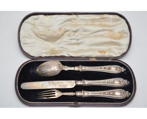 A William IV christening knife, fork and spoon set, by Martin Hall & Co., Sheffield 1835, decorated with leaf and scroll desi