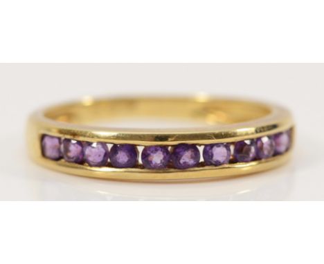A 9ct gold amethyst half eternity ring, channel set, K 1/2, 1.6g