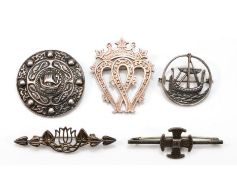 A Scottish silver Luckenbooth brooch, by MG, Glasgow and four other Celtic silver brooches, 36gm