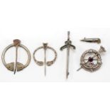 A Scottish silver and paste brooch, 50mm and four other Celtic brooches, 31gm