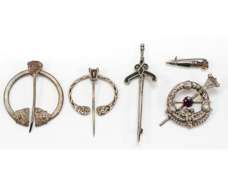 A Scottish silver and paste brooch, 50mm and four other Celtic brooches, 31gm