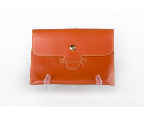 A FENDI VINTAGE ORANGE COWHIDE CLUTCH A vintage 1980's classic design, with gold-tone hardware Fendi 30cm wide x 21cm high Co