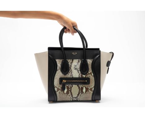 A CELINE 'NANO' LUGGAGE LEATHER HANDBAG
With top handles, front zipper with a python body with black leather trim and cream l