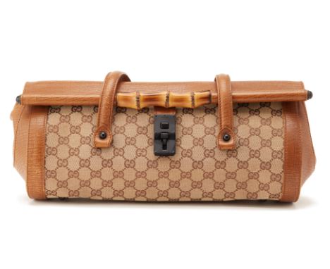 A VINTAGE GUCCI GG BAMBOO BULLET SHOULDER BAG
With a canvas body and leather trim, flat leather handles, a front flap with pu
