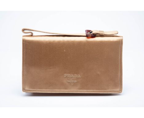 A VINTAGE PRADA METALLIC GOLD SATIN CLUTCH BAG
With embroidered Prada logo, tortoiseshell buckle, three compartment interior 