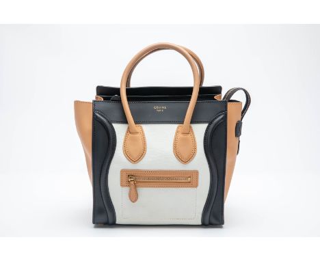 A CELINE LEATHER MINI LUGGAGE TOTE BAG
In tan, black and white with a grain and smooth leather body, top handles, front zippe