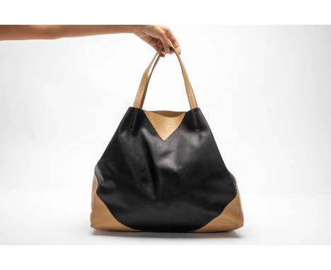 A CELINE BI-COLOUR LEATHER TOTE
In black and tan leather, the interior with a single zip lined enclosure

With dust bag (dust