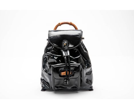 A GUCCI BAMBOO LINE BACKPACK HANDBAG
1990s, With a patent leather high-shine finish, and drawstring top, silver-tone hardware