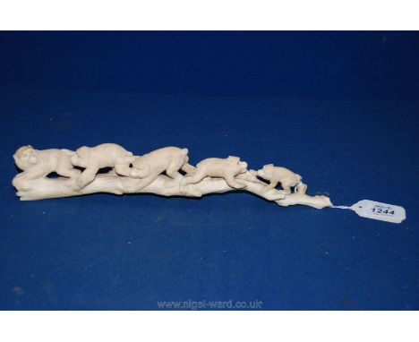 An antique Ivory Carving of five baboons climbing on a tree trunk, 12" long