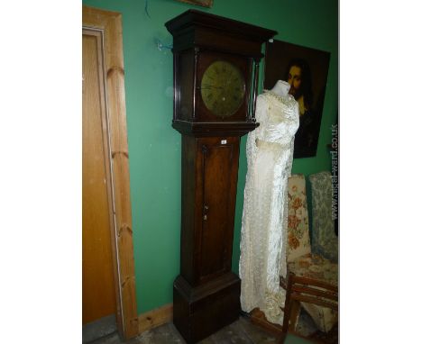 An interesting country made Oak Longcase Clock having moulded cornice hood with turned supports, circular brass face with Ara