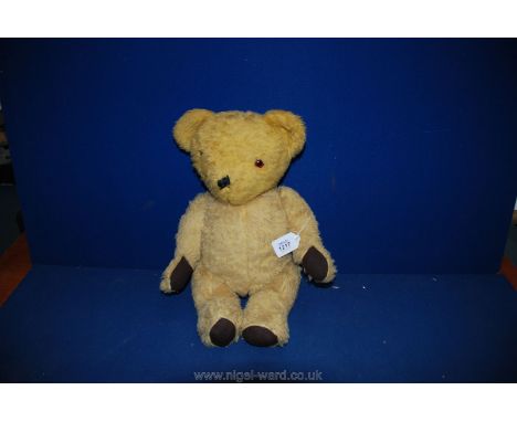 A straw filled, jointed Teddy Bear, 18" tall