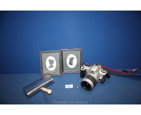 A Canon camera, two framed silhouettes initialled F. R. and an L E Grillom crumb sweeper
