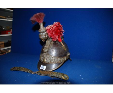 A French Cavalry Helmet dated 1878 no. 59 with Medusa head, skull protector and chin straps present, comb and tail missing