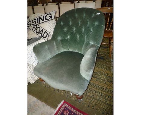 A 19th c. green dralon, button back Armchair on turned mahogany front legs.