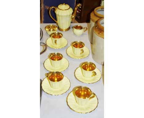 A 15 piece Wade coffee set comprising coffee pot, sugar, milk, 6 cups and saucers, daffodil yellow with gilt interiors