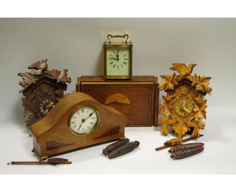 Two Black Forest style cuckoo clocks, a 1940's mantel clock; a Smith's carriage clock; a marquetry box with hinged cover.