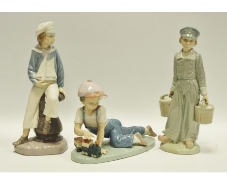 Lladro - ''All Aboard'' figure of a boy with train, printed marks to base, pattern number 7619, boxed;  another Lladro figure