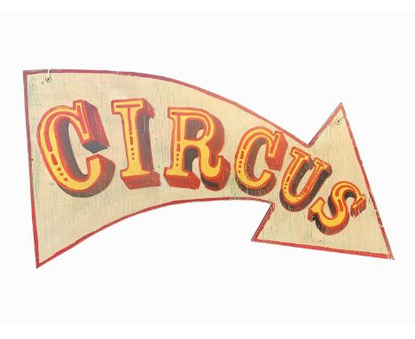 A sign written wooden sign in the shape of an arrow 'CIRCUS'. 67 x 115cm (irregular).