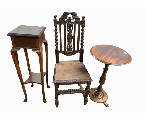 A Victorian carved oak side chair, a Victorian mahogany tripod table and a mahogany plant stand.