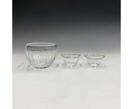 A pair of 18th century small conical glass bowls, with folded rims, diameter 7.5cm, together with a glass caddy liner (2).