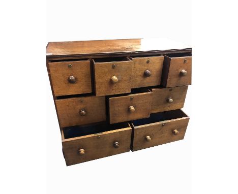 A teak bank of drawers, circa 1800, with an arrangement of nine drawers and turned wooden knobs, on bracket feet, height 89cm