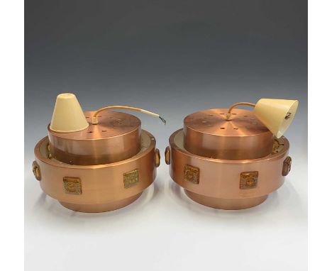 A pair of 1970s copper finish hanging light pendants, each of three tiers, the central tier inset with seven moulded amber gl