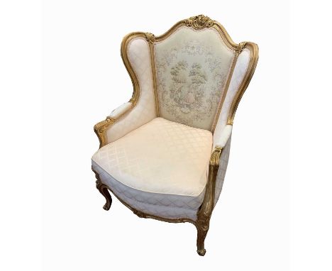 A French style gilt decorated armchair, of Louis XVI style, with machine tapestry back, shell and scroll carved frame, on mou