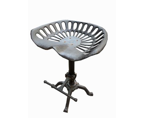 An industrial type stool with tractor style seat. Height 64cm.