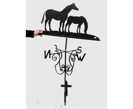 A wrought metal weather vane surmounted by a mare and foal. Height 154cm.