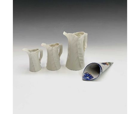 A set of three graduated Royal Worcester leaf moulded jugs, tallest 14.5cm high, together with a Quimper wall pocket (4).