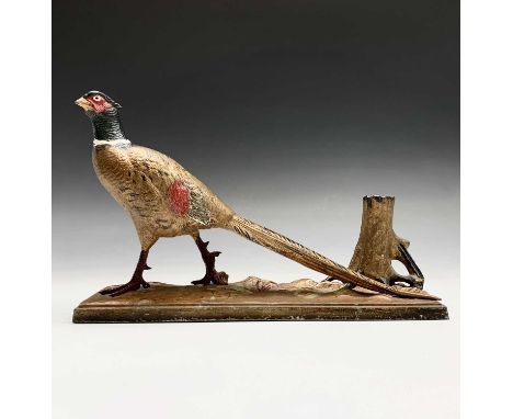 A painted spelter table lighter, modelled as a cock pheasant beside a tree stump on a naturalistic rectangular base, width 31