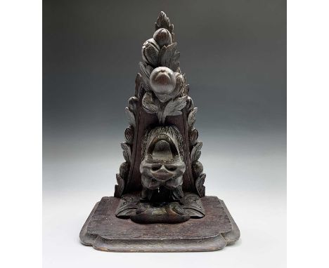 A Victorian carved oak wall bracket, carved with a lion's head, fruit and foliage, height 46cm.