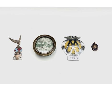 A vintage brass tax disc holder, containing four BSA motorcycle tax discs - 1940-1945, a R.A.F.A. enamel car badge, an AA car