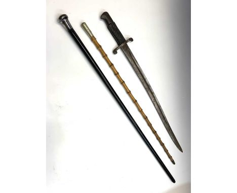 A cane Loyal Regiment swagger stick, length 71cm, together with a bayonet and a silver mounted ebony cane (3).