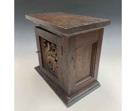 Arts &amp; Crafts walnut collector's cabinet, a single door with acanthus carved panel enclosing three drawers. Height 35cm, 