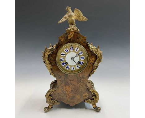 A 19th century French Louis XVI style walnut and floral marquetry inlaid mantel clock with ormolu eagle finial and Rococo scr